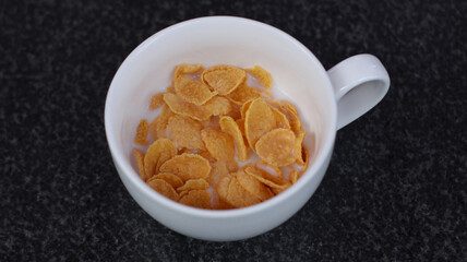 cup of cereal cornflakes for breakfast                               
