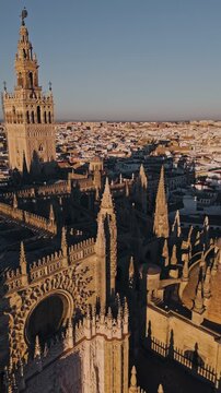 Stunning drone panorama of seville cathedral at sunset captures architectural majesty