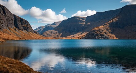 Naklejka premium A remote highland lake with clean sparkling water and rugged cliffs