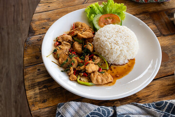 Seafood fried rice with egg, served on a white plate, on a wooden table, ready to serve. Thai food, close up food.