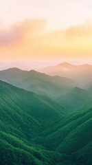 Fototapeta premium Sunrise Over Lush Green Mountain Range Scenic Nature View in Vertical Composition with Soft Pastel Sky and Mist Covered Valleys for Serene Landscape Photography and Tranquil Meditation Settings