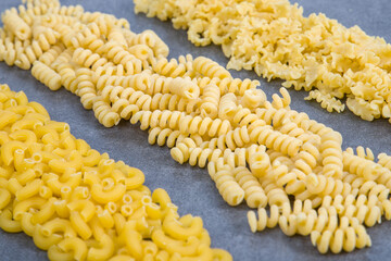 Variety of types and shapes of Italian pasta. Dry pasta background