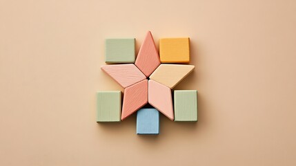 Obraz premium Pastel wooden blocks arranged in the shape of a star on a neutral background