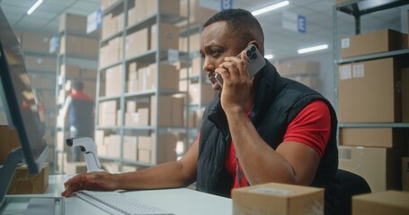 Warehouse facility of post office or E-commerce store: African American logistics coordinator talks...