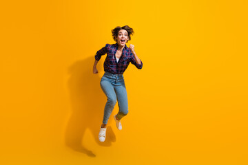 Full length photo of eccentric crazy woman dressed plaid shirt jeans run shopping on black friday isolated on yellow color background