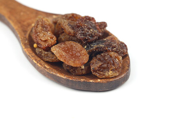 Mix of nuts and dried fruits in wooden spoon isolated on a white background.