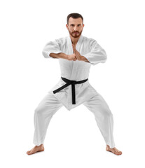 Man in uniform practicing karate on white background
