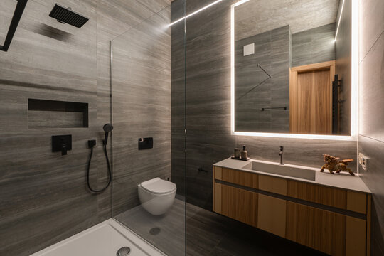 The modern bathroom showcases a minimalist design complemented by elegant and stylish fixtures