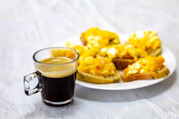 A minimalist breakfast classic, bread, scrambled eggs and coffee