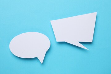 Blank speech bubbles on light blue background. Space for text