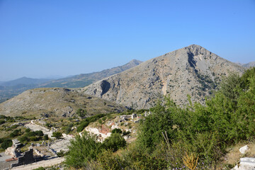 high mountains with a green tree and blue sky  