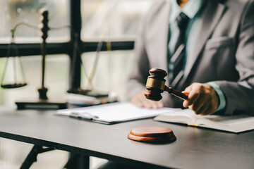Close-up focuses on judge's hammer on lawyer's table Male consultant or lawyer working in the office Legal concepts, advice
