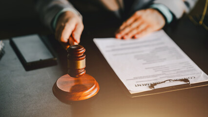 Close-up focuses on judge's hammer on lawyer's table Male consultant or lawyer working in the office Legal concepts, advice