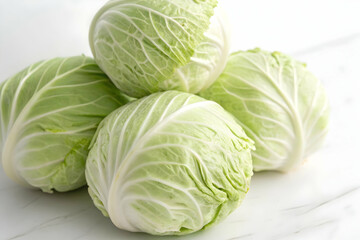 Fototapeta premium Fresh White Cabbage Heads on Light Background - Organic Cruciferous Vegetable