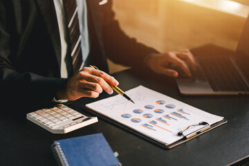 Portrait working in finance using tablet computer and calculator in modern office, preparing analytical reports, accounting information, real estate investment, financial and tax concepts.