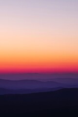 Fototapeta premium A blurred gradient summer background with warm sunset colors, orange and purple tones