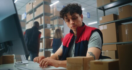Slow motion of inventory manager scanning parcel with barcode scanner, preparing for shipping to customer, working on computer. Warehouse employees carrying boxes. E-commerce store or postal service.