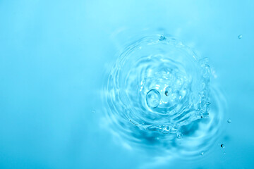 Water Splash Droplet Ripple in Clear Blue Liquid Surface