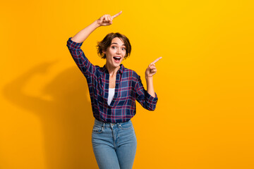 Portrait of impressed ecstatic girl wear checkered shirt indicating at unbelievable sale empty...