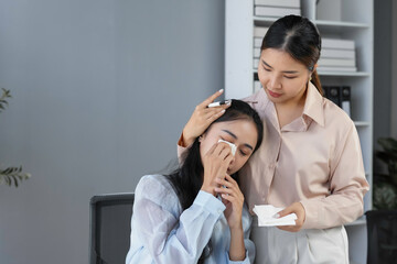 Kind manager offering support and comfort to her upset, crying employee in the office, fostering...