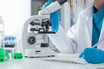 Asian woman scientist and tube doing experiments for research Innovative microbiology or drug trials to extend life Science and Chemistry