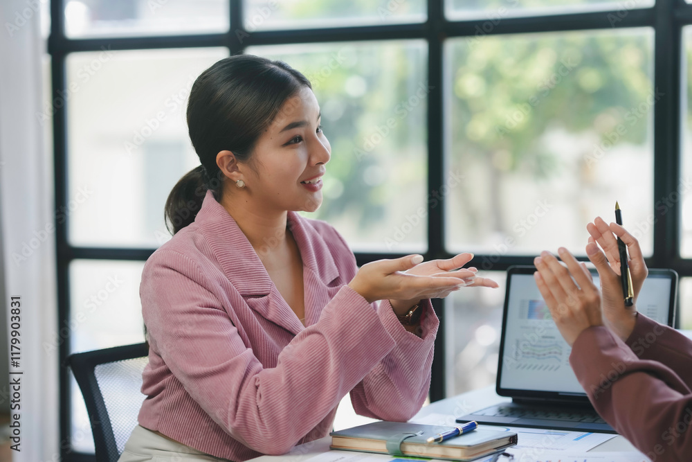 Poster two businesswomen engaging in a discussion about graphs while collaborating in an office setting, su