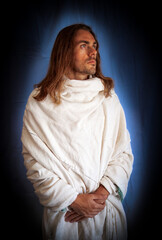 Good-looking, long-haired man with a beard and a blue halo dressed in a robe like a spiritual Christ-like man