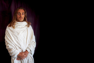 A long-haired man in a white robe resembling Jesus