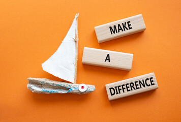 Make a difference symbol. Concept words Make a difference on wooden blocks. Beautiful orange...