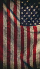 The waving American flag, a patriotic symbol of the United States, displays its iconic stars and stripes of red, white, and blue