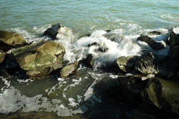 Strong splashes of the sea. strong wave crashed into the rocks and strong drops of water in the air.