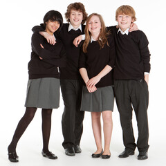 Early Teenage Students: Mixed Friends. A relaxed portrait of a group of early teenage school friends isolated against a white background.