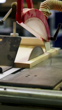 Cutting a Wooden Board on a Woodworking Machine