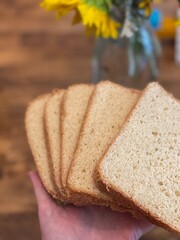 Fresh Baked Sandwich Bread Slices Held in Hand.