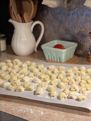 Homemade Potato Gnocchi on Kitchen Counter on Baking Tray with Parchment Paper.