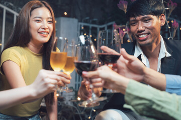 Cheers to Friendship: A group of happy friends raise their wine glasses in a celebratory toast, enjoying a night out together.