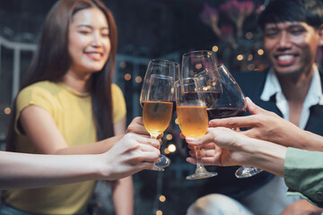 Cheers to Friendship: A joyous celebration captured in a close-up shot of diverse friends raising their glasses in a toast, symbolizing connection, camaraderie, and shared moments of delight.