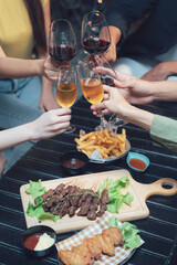 Cheers to Friendship: A toast to good times and close connections, captured in a warm and inviting image of friends enjoying a delicious meal and a glass of wine together.  