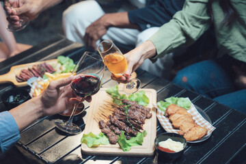Cheers to Connection:  A heartwarming image of friends raising their glasses in a toast, surrounded by a spread of delicious food.
