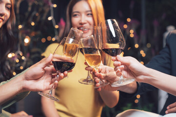 Cheers to Celebration: A group of friends raises their glasses in a toast, capturing the joy and camaraderie of a special occasion. The warm.