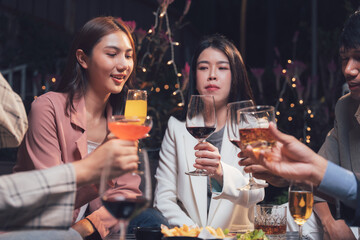Night Out Toasting:  A group of friends raise their glasses in a toast, celebrating a night out together.