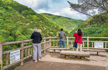 Tourists taking photos with the beautiful scenic landscape from Arashiyama Park viewpoint, in...
