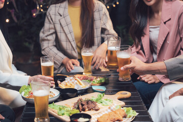 Night Out with Friends:  Sharing laughter, drinks, and delicious food with friends at a cozy outdoor gathering.  A moment of carefree joy and connection. 