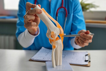 Doctor shows anatomy of structure of human knee joint concept