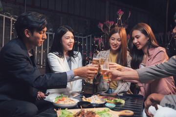 Night Out Cheers: Friends raise a toast, celebrating together at a lively outdoor restaurant.  The warm lighting and happy expressions capture the essence of friendship and good times. 