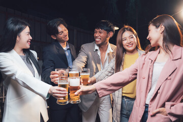 Cheers to Connection: A diverse group of friends raises their glasses in a toast, their smiles and laughter capturing the warmth and camaraderie of a shared moment.