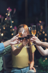 Cheers to Friendship: A heartwarming toast among friends, captured in a dimly lit setting, with warm bokeh lights in the background, creating a festive ambiance.  