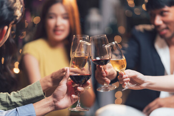Toasting to Togetherness: Friends raise a toast, wine glasses clinking in a warm, intimate setting, capturing the essence of friendship and celebration.