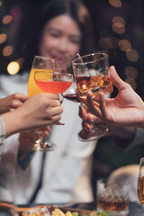 Cheers to Friendship: A close-up shot of hands clinking glasses, capturing the joy and camaraderie of a celebratory gathering.