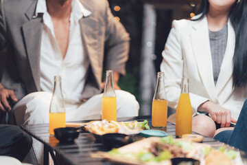 Social Gathering:  Friends enjoy refreshments and snacks together, capturing the essence of casual camaraderie and relaxed socializing.  